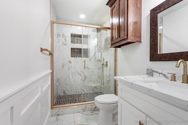 bathroom with vanity, a shower with shower door, and toilet