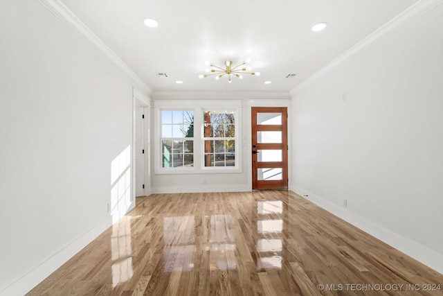 interior space featuring a notable chandelier, light hardwood / wood-style floors, and crown molding