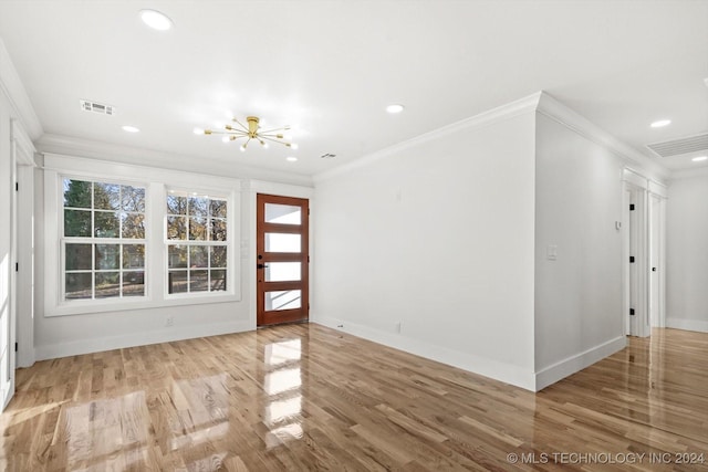 interior space featuring light hardwood / wood-style floors, an inviting chandelier, and crown molding