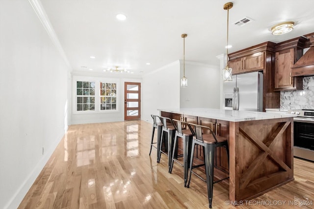 kitchen with backsplash, light wood-type flooring, ornamental molding, decorative light fixtures, and stainless steel appliances