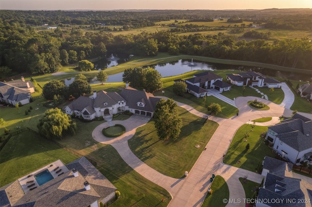 aerial view at dusk with a water view