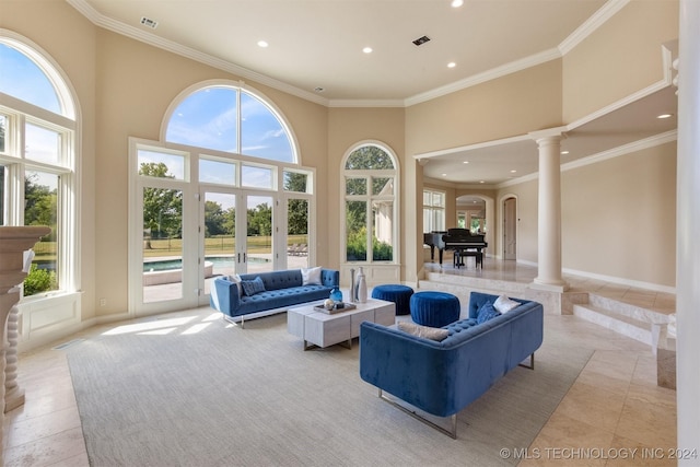 living room featuring a towering ceiling, crown molding, and french doors