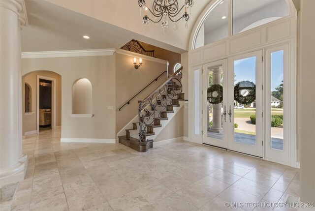 3520 W 77th St S, Tulsa, OK 74132 - entryway featuring crown molding, stairs, recessed lighting, arched walkways, and a chandelier