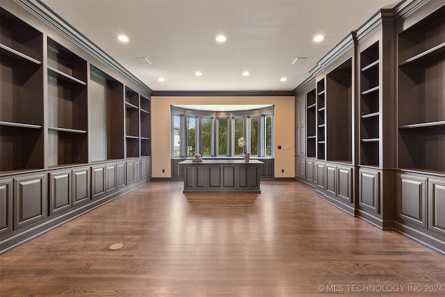 interior space with dark hardwood / wood-style floors and ornamental molding