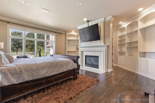 bedroom with a fireplace, dark hardwood / wood-style floors, and ornamental molding