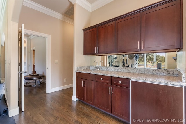 kitchen with light stone countertops, sink, dark wood-type flooring, and ornamental molding