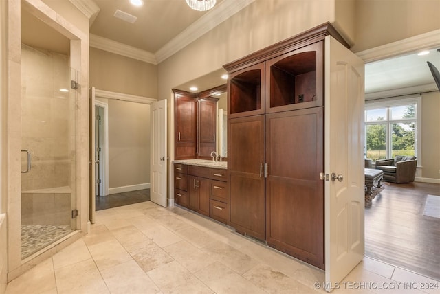 bathroom with wood-type flooring, vanity, an enclosed shower, and crown molding