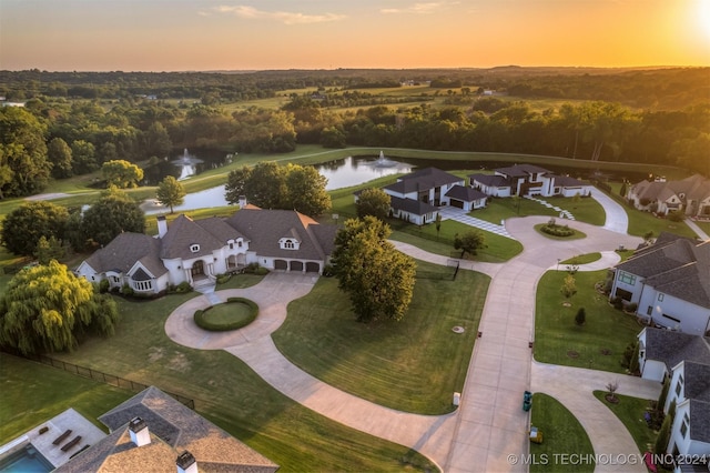 aerial view at dusk with a water view