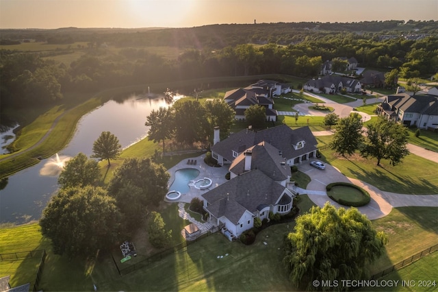 aerial view at dusk with a water view