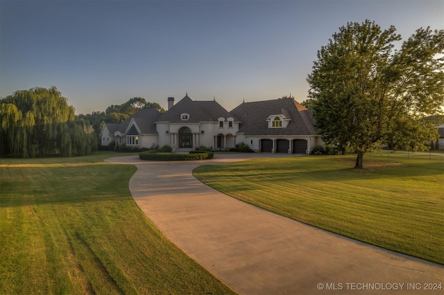 french provincial home featuring a yard