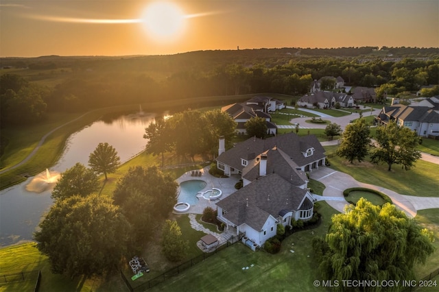 aerial view at dusk with a water view