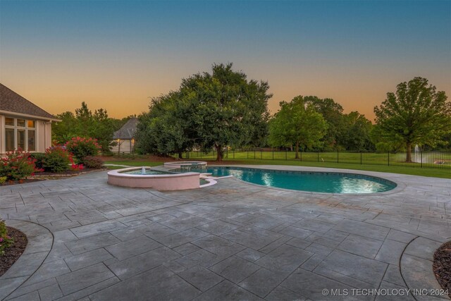 3520 W 77th St S, Tulsa, OK 74132 - pool at dusk with a patio area and a pool with connected hot tub