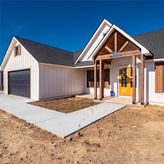 modern inspired farmhouse with covered porch and a garage