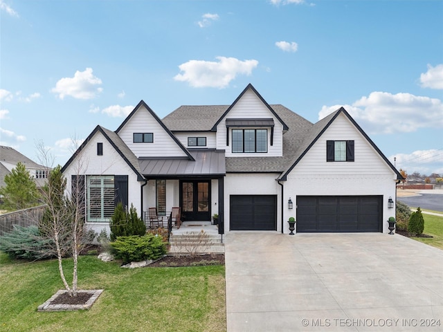 modern farmhouse style home featuring a porch, a garage, and a front lawn