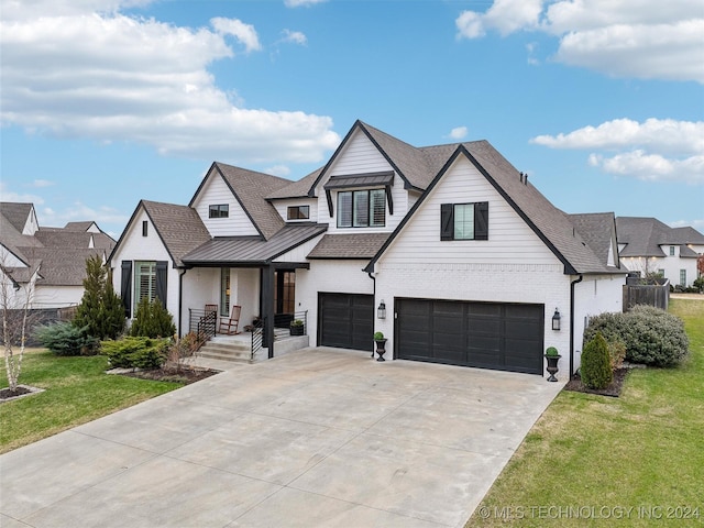 modern farmhouse featuring a garage and a front lawn