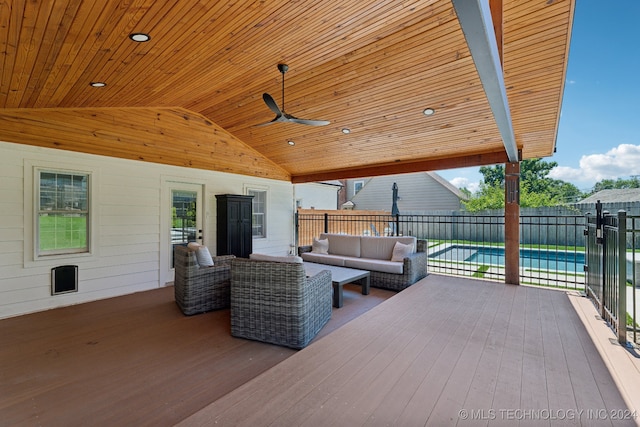 wooden terrace featuring ceiling fan and an outdoor living space