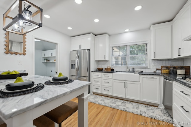 kitchen featuring white cabinets, sink, and appliances with stainless steel finishes