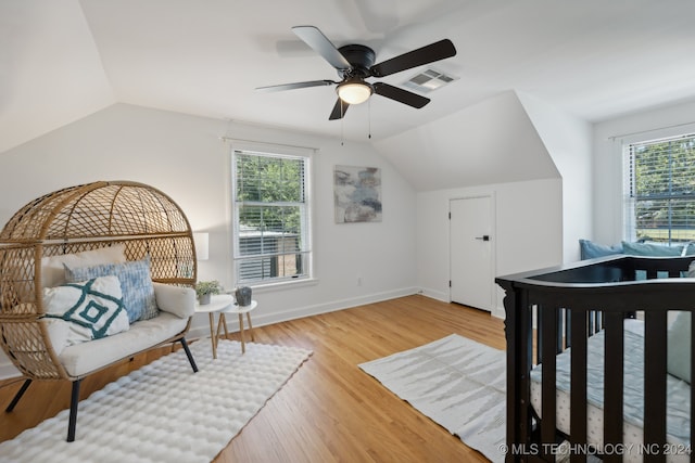 bedroom featuring ceiling fan, wood-type flooring, and vaulted ceiling