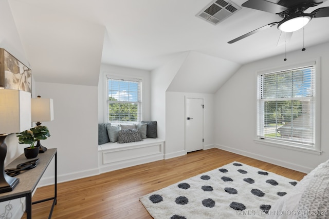 bedroom featuring multiple windows, ceiling fan, hardwood / wood-style floors, and vaulted ceiling