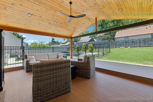 exterior space with an outdoor living space, ceiling fan, and a deck