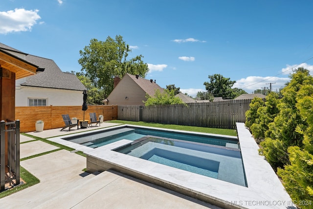 view of pool featuring an in ground hot tub and a patio area