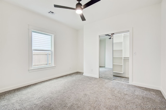 unfurnished bedroom with light carpet, a closet, and ceiling fan