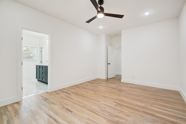 empty room with light hardwood / wood-style floors and ceiling fan