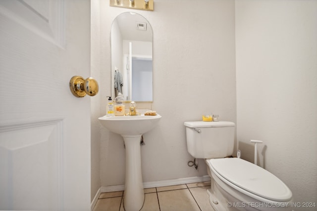 bathroom with tile patterned flooring and toilet