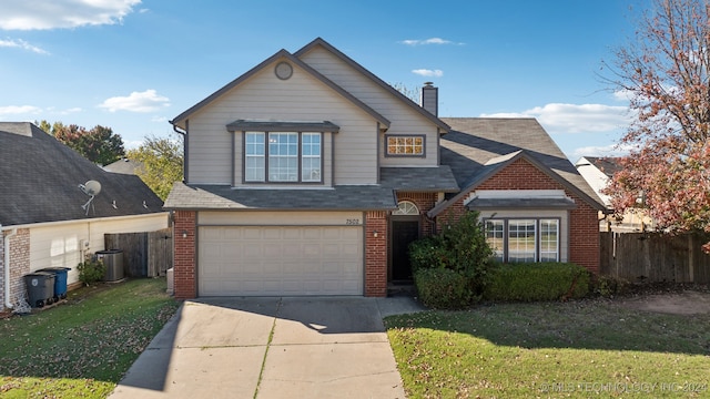 front of property featuring a front yard, a garage, and central AC unit