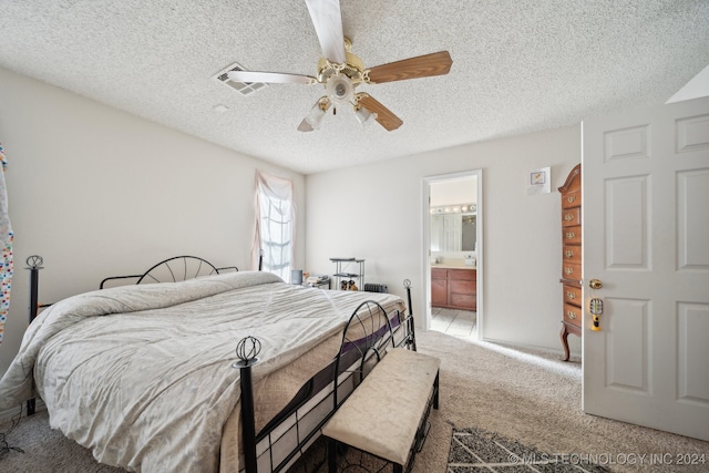 carpeted bedroom with a textured ceiling, ceiling fan, and connected bathroom