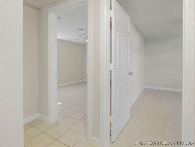 hall featuring light tile patterned floors