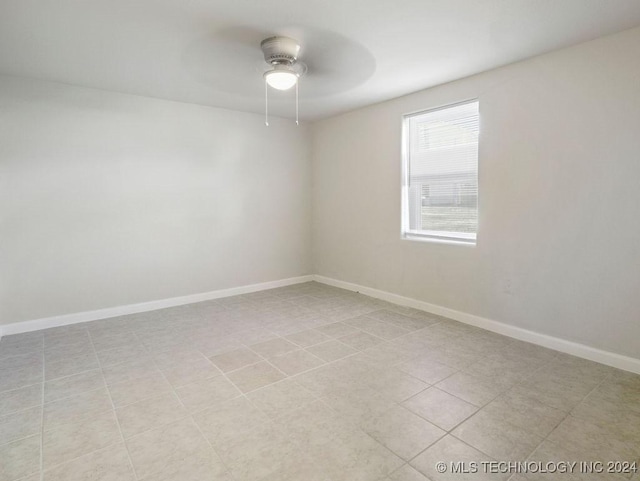 empty room featuring ceiling fan and light tile patterned flooring