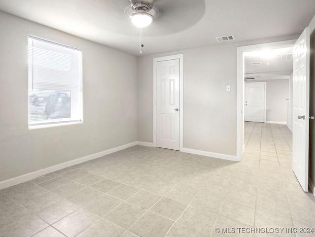 unfurnished room featuring ceiling fan and light tile patterned floors