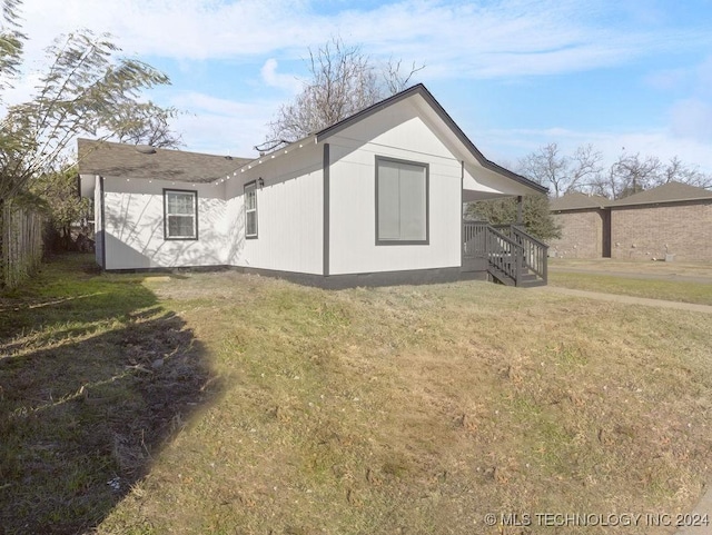 rear view of house with a lawn