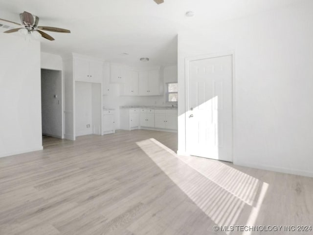 unfurnished living room featuring light hardwood / wood-style floors and ceiling fan