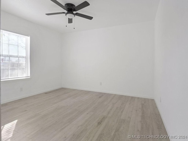 empty room featuring ceiling fan and light hardwood / wood-style floors