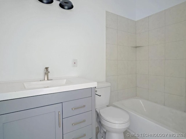 full bathroom with vanity, tiled shower / bath combo, and toilet