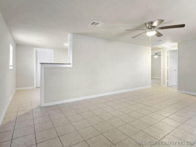 empty room featuring ceiling fan and light tile patterned floors