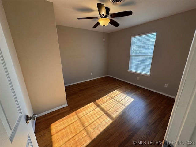 spare room featuring dark hardwood / wood-style floors and ceiling fan