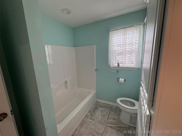 bathroom featuring bathtub / shower combination and toilet