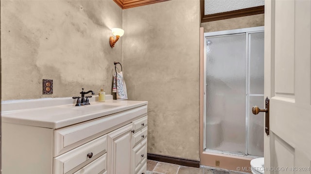 bathroom with crown molding, vanity, and an enclosed shower