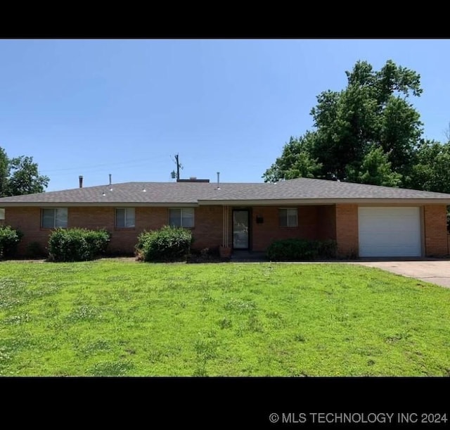 single story home featuring a garage and a front lawn