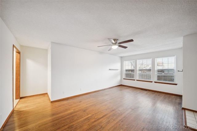 unfurnished room featuring ceiling fan, a textured ceiling, and light hardwood / wood-style flooring