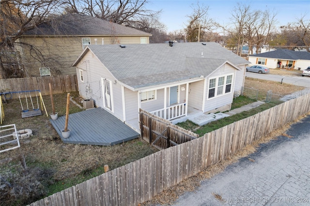 back of house featuring a porch and central AC