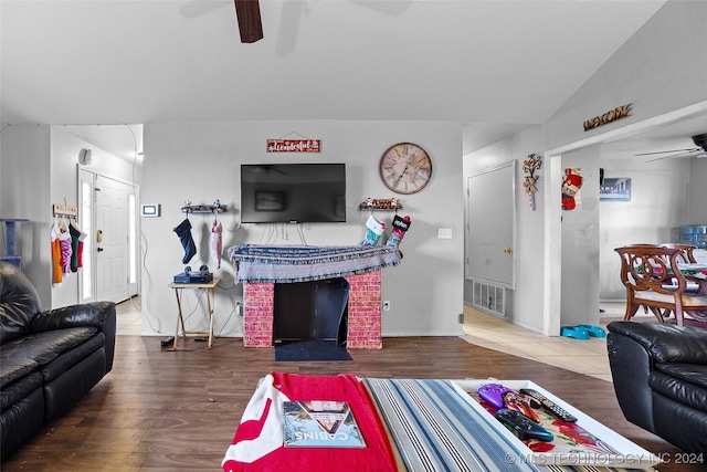 living room with hardwood / wood-style floors and lofted ceiling