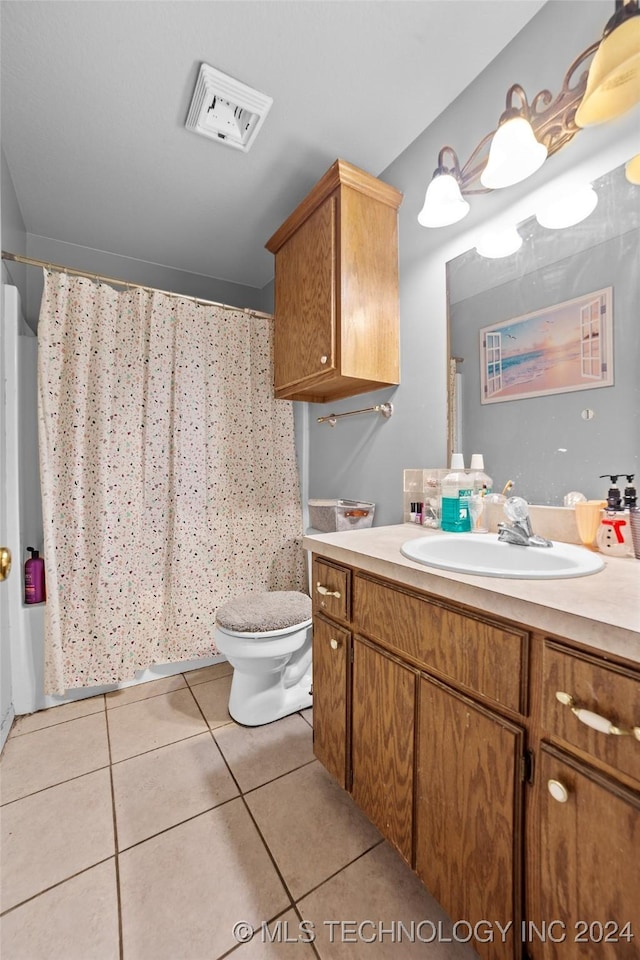 bathroom with tile patterned floors, vanity, curtained shower, and toilet