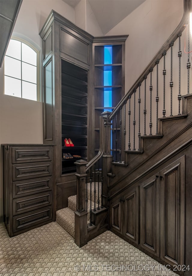 stairs featuring lofted ceiling