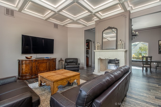 living room featuring beam ceiling, coffered ceiling, a chandelier, wood-type flooring, and ornamental molding