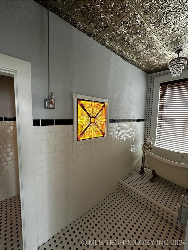 bathroom featuring a tub and tile walls