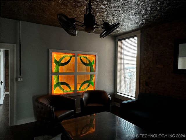 dining space featuring brick wall